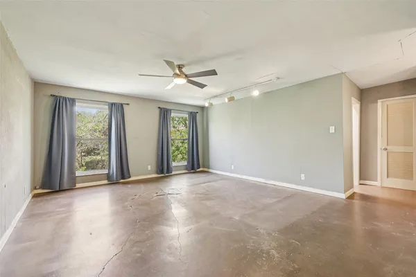 a view of a livingroom with a ceiling fan and window