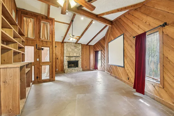 a view of a livingroom with a fireplace and cabinet