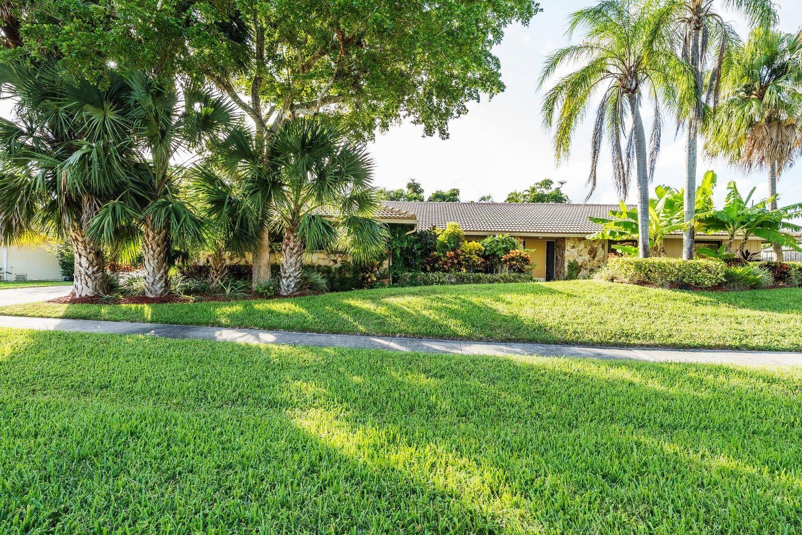 6761 Entrada Place Boca Raton, FL 33433 - Photo 4 of 69 a front view of a house with a yard