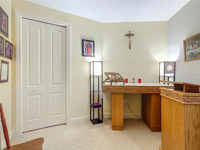 a bedroom with a bed and painting on the wall