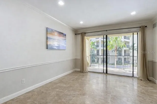 a bedroom with a bed and painting on the wall