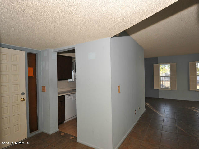 600 East River Road, Unit P Tucson, AZ 85704 - Photo 8 of 28 a view of an empty room with window and wooden floor