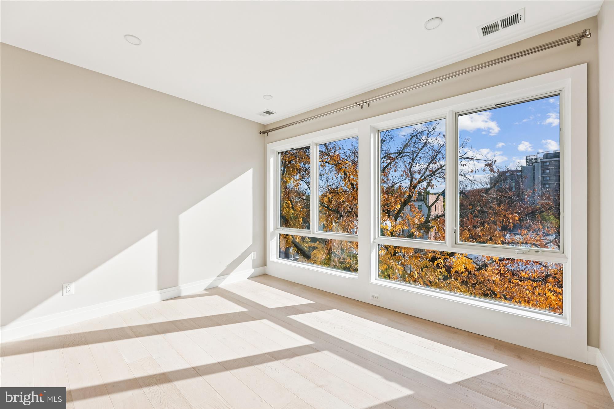1102 Staples Street Northeast, Unit 301 Washington, DC 20002 - Photo 11 of 24 a view of a hallway with wooden floor and a fireplace