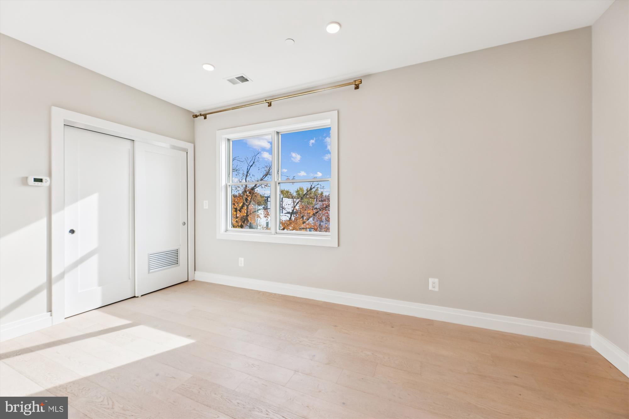1102 Staples Street Northeast, Unit 301 Washington, DC 20002 - Photo 6 of 24 an empty room with windows