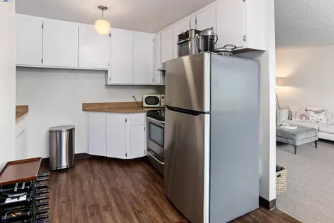 a kitchen with stainless steel appliances a refrigerator sink and cabinets