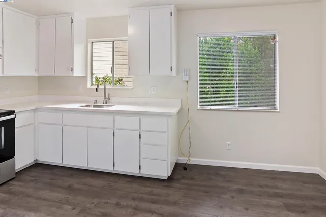 a kitchen with a sink cabinets and a window