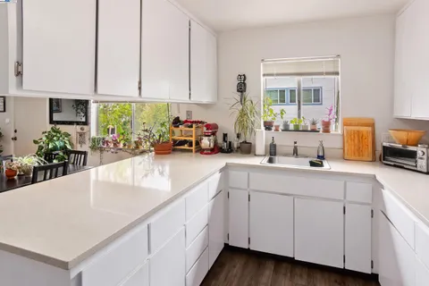 a kitchen with white cabinets and a sink