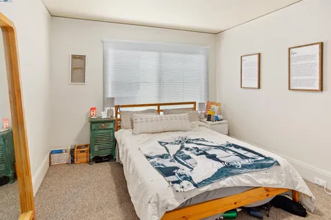 a bedroom with a bed and a lamp with window