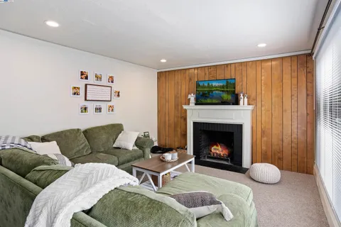 a living room with furniture a fireplace and a flat screen tv