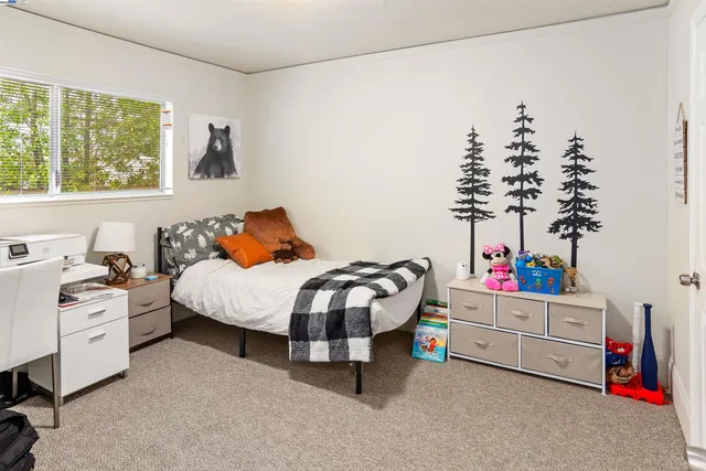 a bedroom with a bed and a window