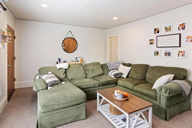 a living room with furniture and a air conditioner vent