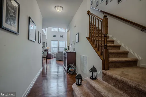 a kitchen with stainless steel appliances granite countertop a sink dishwasher stove and refrigerator with wooden floor