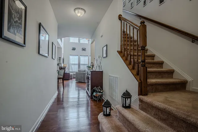 a kitchen with stainless steel appliances granite countertop a sink refrigerator and cabinets