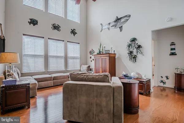a living room with furniture and kitchen view