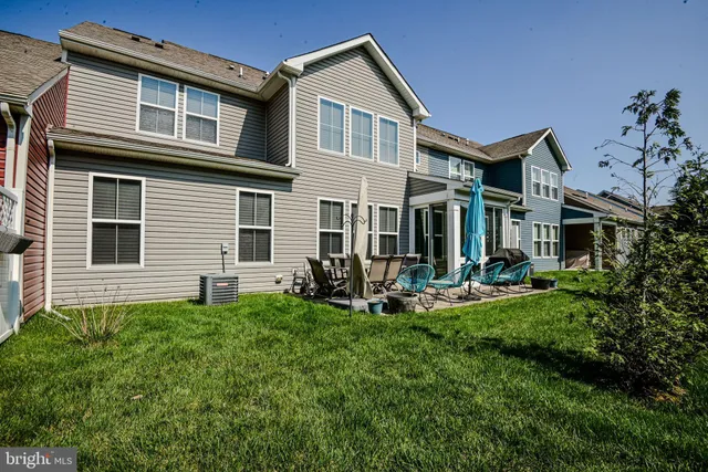 a front view of a house with a garden and plants