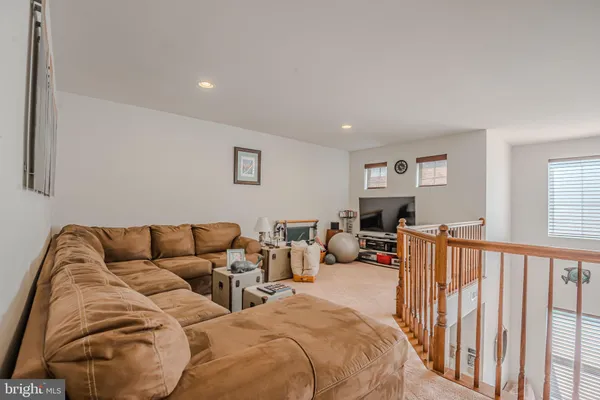 a living room with furniture a rug and a flat screen tv