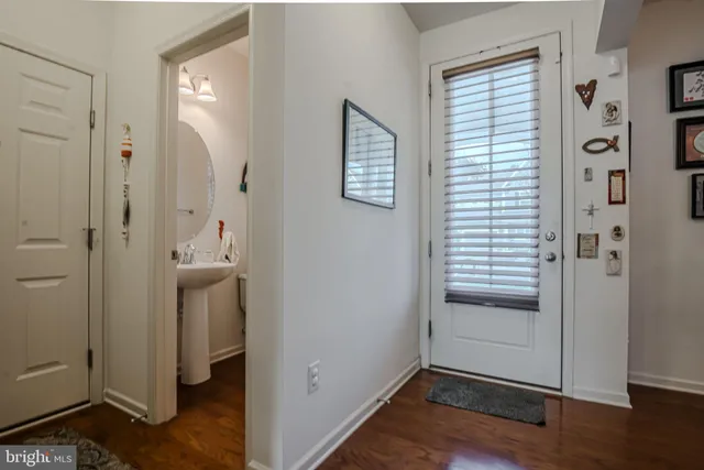 a view of living room and kitchen with wooden floor