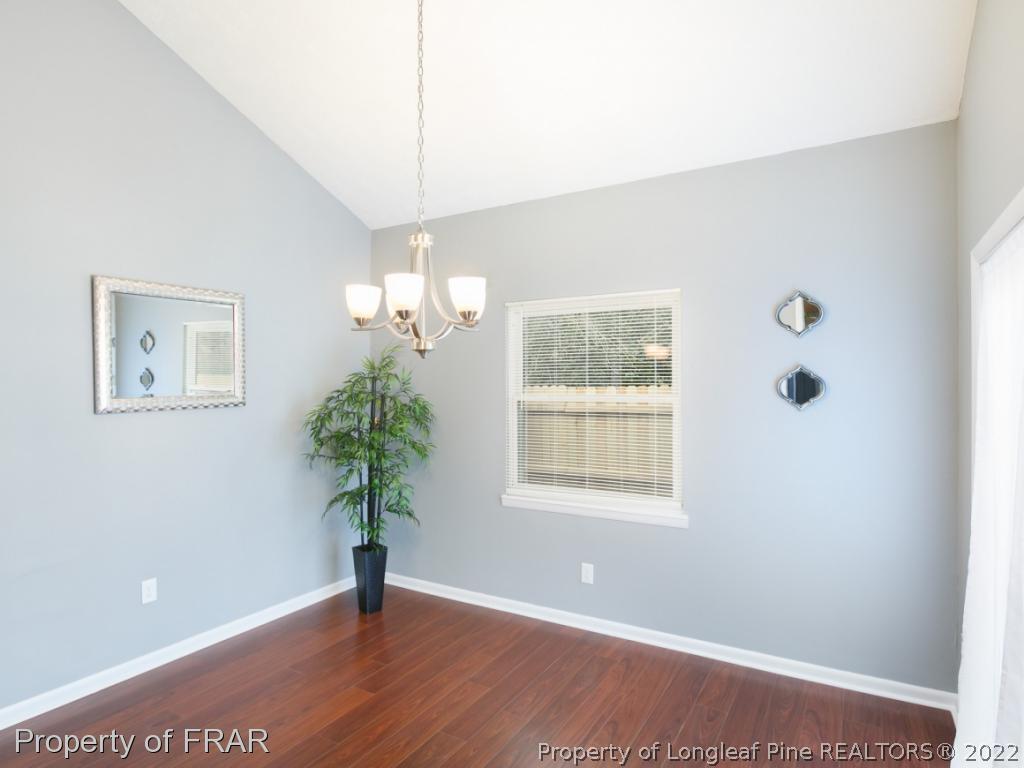 1007 Landau Road Fayetteville, NC 28311 - Photo 20 of 34 a view of an empty room with a window and wooden floor