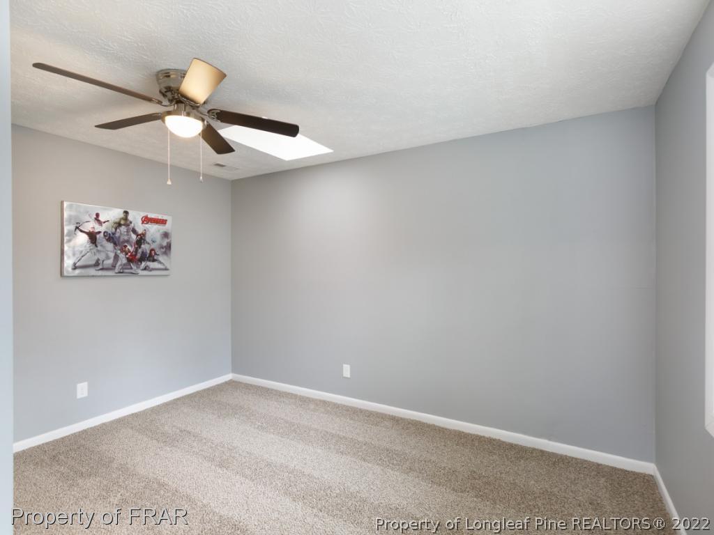 1007 Landau Road Fayetteville, NC 28311 - Photo 22 of 34 an empty room with a window and a ceiling fan