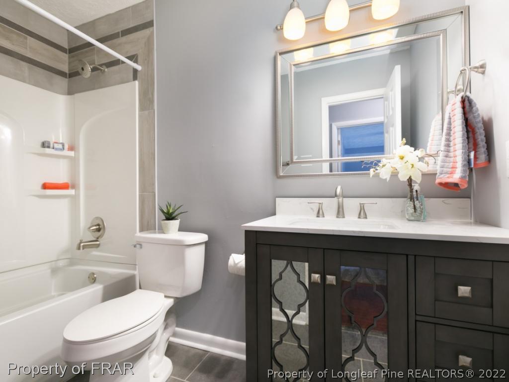 1007 Landau Road Fayetteville, NC 28311 - Photo 24 of 34 a bathroom with a toilet sink and mirror
