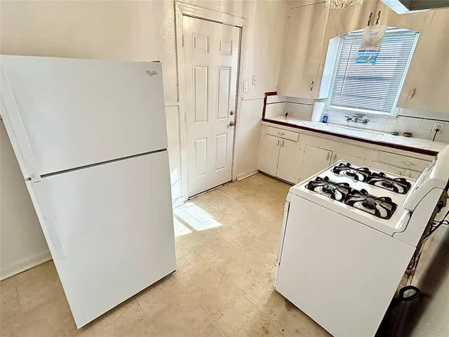 a white refrigerator freezer sitting inside of a kitchen