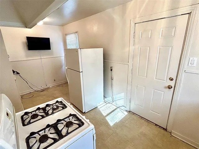 a kitchen with stainless steel appliances a refrigerator and a stove top oven