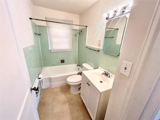 a bathroom with a sink a toilet a mirror and shower