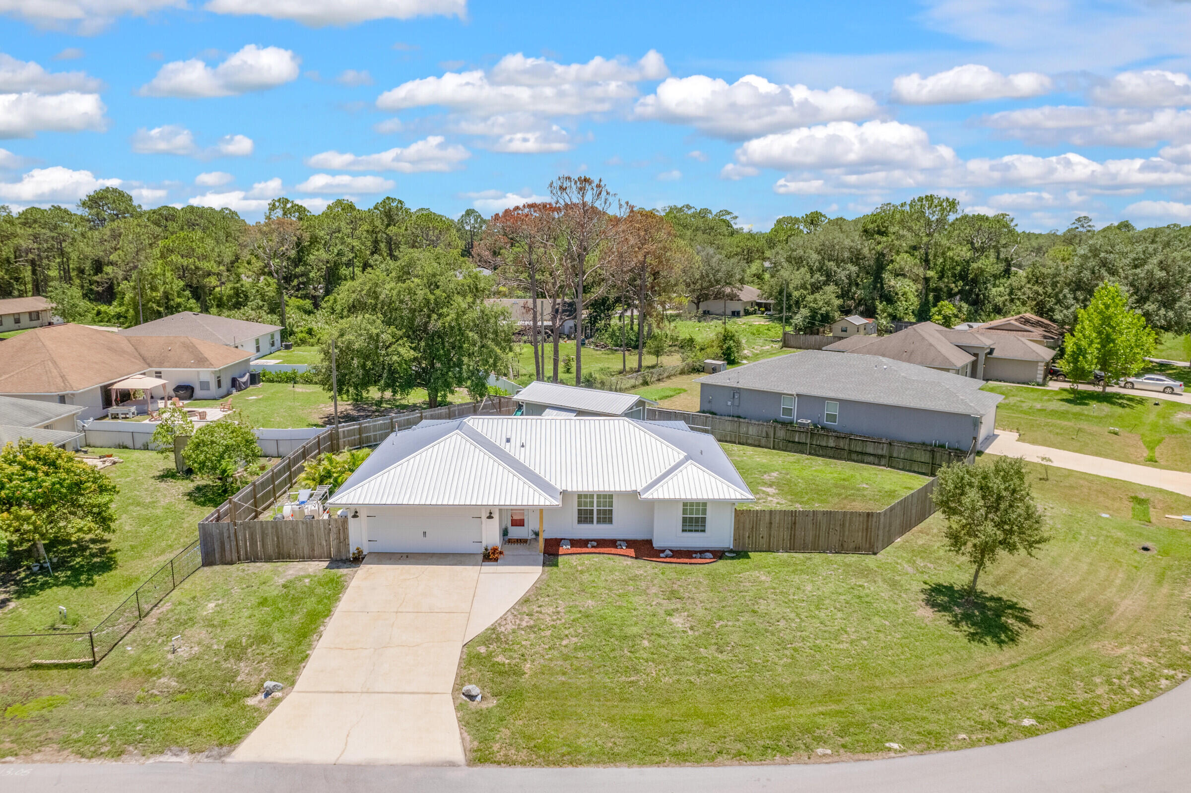 1030 San Rafael Road Southwest Palm Bay, FL 32908 - Photo 33 of 37 a aerial view of a house with swimming pool and trees in the background