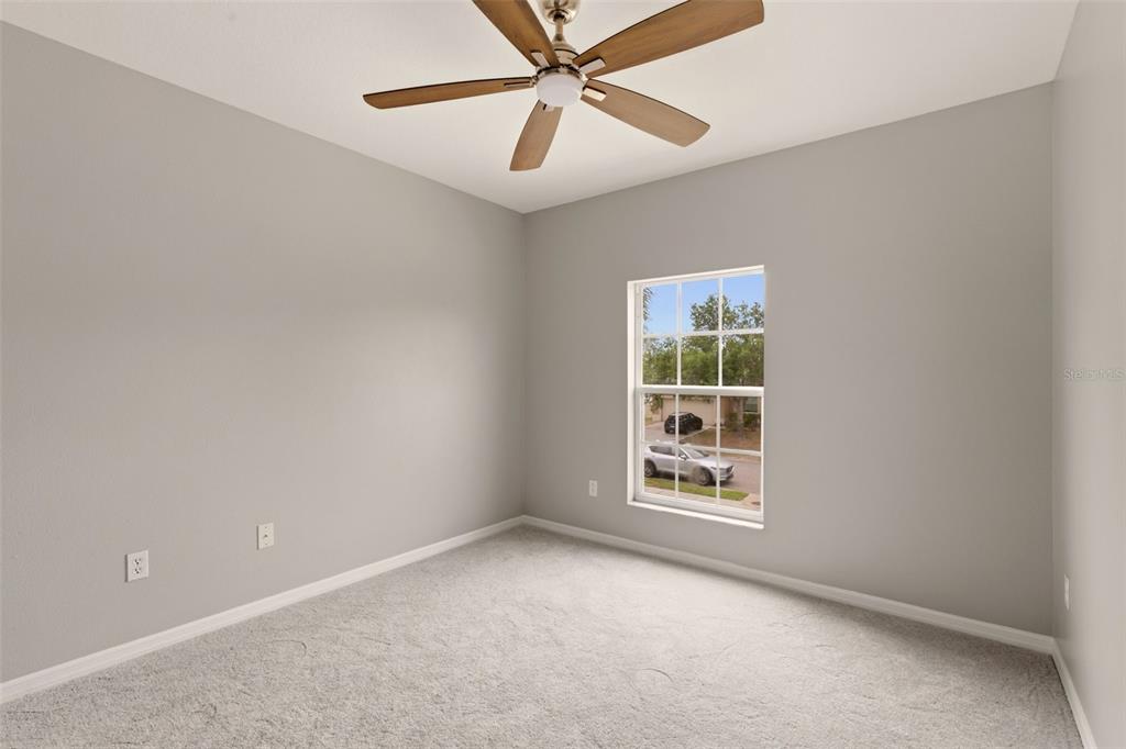 253 Bella Rosa Circle Sanford, FL 32771 - Photo 11 of 22 an empty room with a window and a ceiling fan