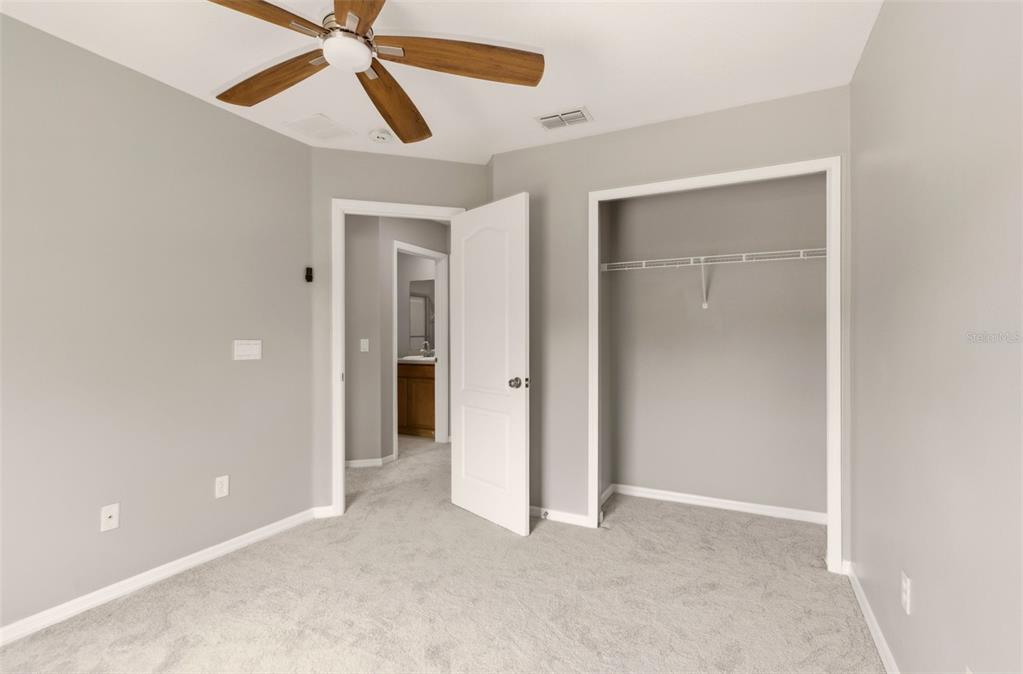 253 Bella Rosa Circle Sanford, FL 32771 - Photo 12 of 22 an empty room with closet and a chandelier fan