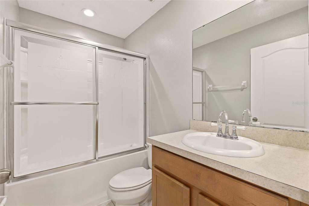 253 Bella Rosa Circle Sanford, FL 32771 - Photo 18 of 22 a bathroom with a sink toilet and shower