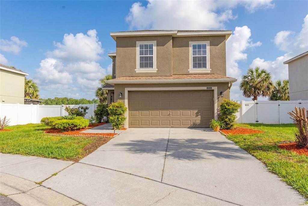 253 Bella Rosa Circle Sanford, FL 32771 - Photo 2 of 22 a front view of a house with a yard and garage
