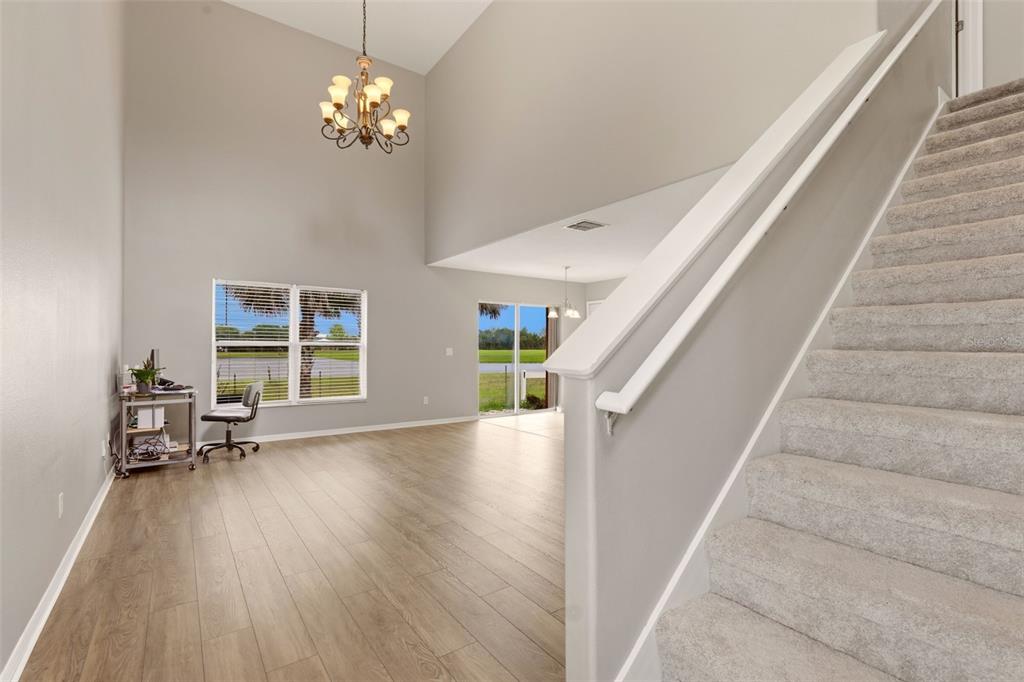 253 Bella Rosa Circle Sanford, FL 32771 - Photo 4 of 22 a view of an entryway with wooden floor and a chandelier