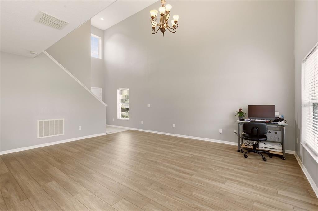 253 Bella Rosa Circle Sanford, FL 32771 - Photo 5 of 22 a view of a livingroom with a piano and wooden floor