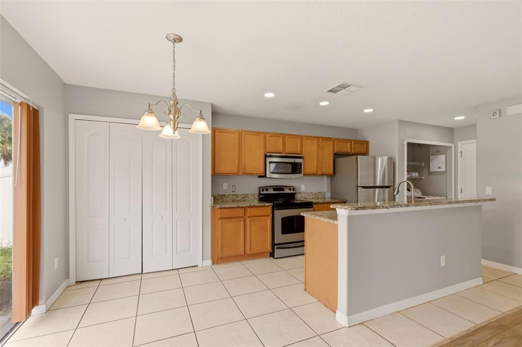 253 Bella Rosa Circle Sanford, FL 32771 - Photo 7 of 22 a kitchen with stainless steel appliances a refrigerator sink and microwave