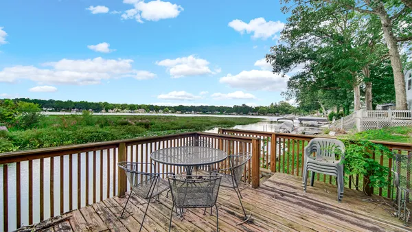 a view of a balcony with two chairs and a table