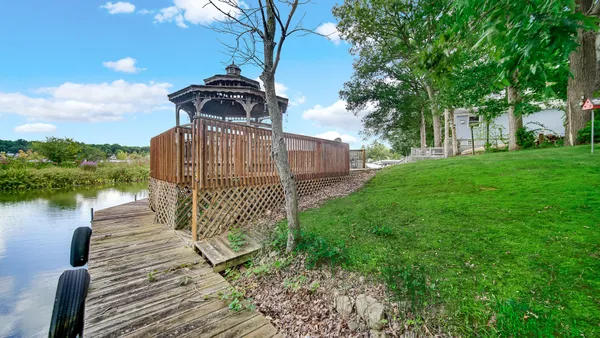 a view of a pathway of a house with a yard