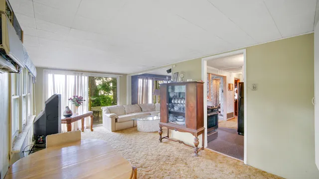 a living room with furniture a rug and a large window