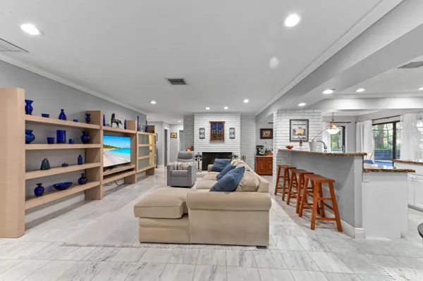 a living room with furniture a flat screen tv and a book shelf