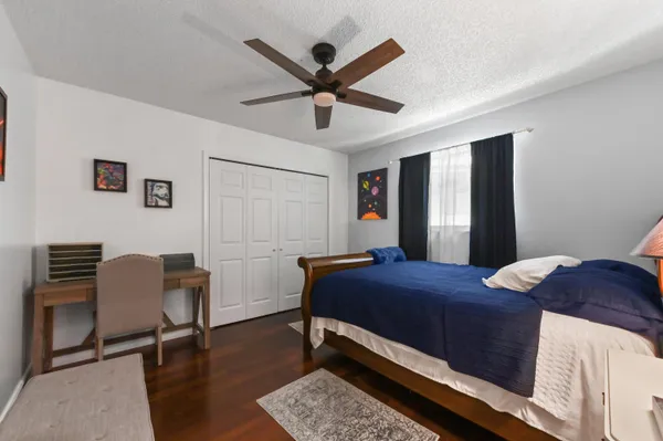 a bedroom with a bed and a desk