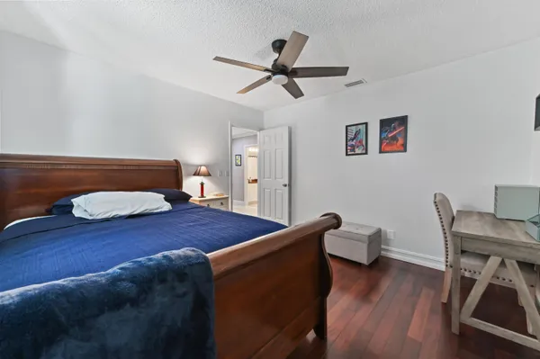 a bedroom with a bed and wooden floor