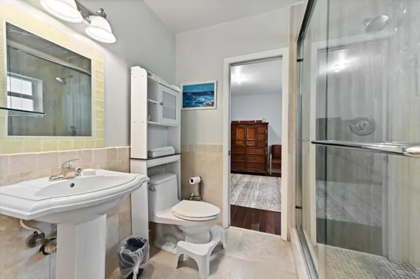 a bathroom with a sink toilet and shower