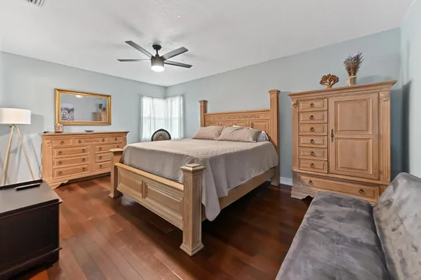 a bedroom with a bed and a chandelier
