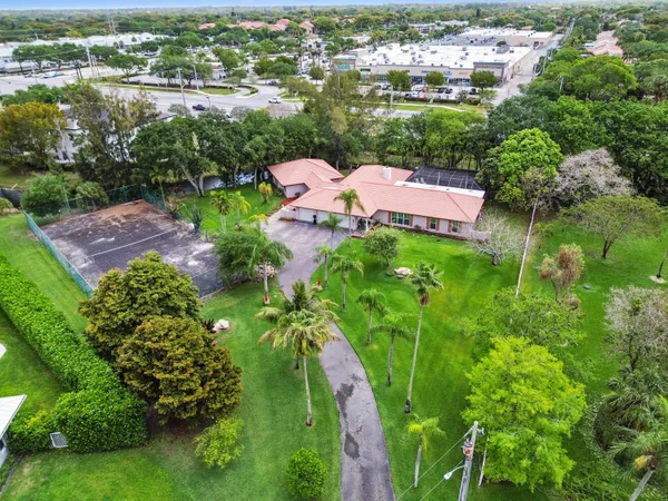an aerial view of a house with a yard swimming pool outdoor seating and yard