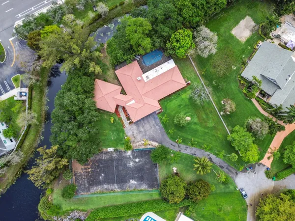 an aerial view of residential houses with outdoor space and street view