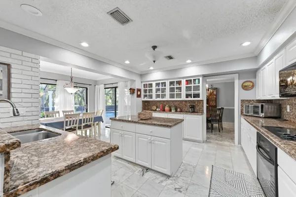 a kitchen with stainless steel appliances granite countertop a sink and cabinets