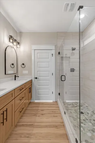 a spacious bathroom with a sink and a shower