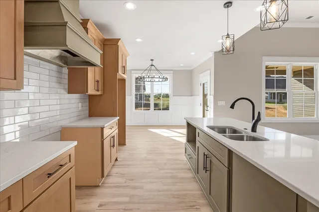 a kitchen with stainless steel appliances granite countertop a sink stove and cabinets