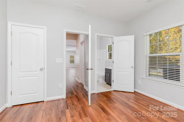 a view of a livingroom with wooden floor and a window