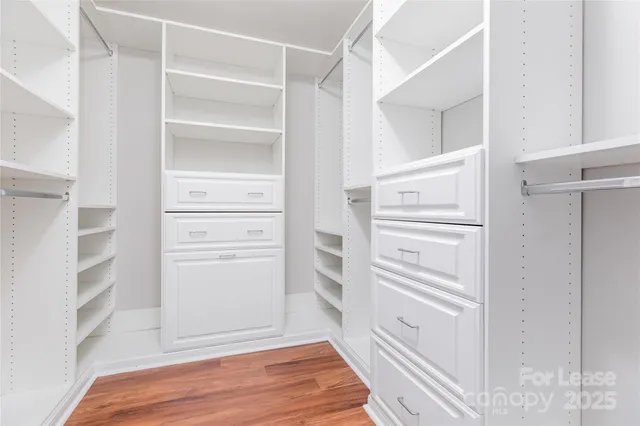 a view of walk in closet with empty racks